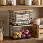 Stacked wire baskets with bamboo lids in a kitchen pantry, holding produce and towels