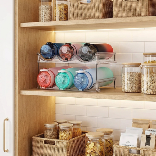 Stackable water bottle organizer racks holding bottles in a pantry cabinet